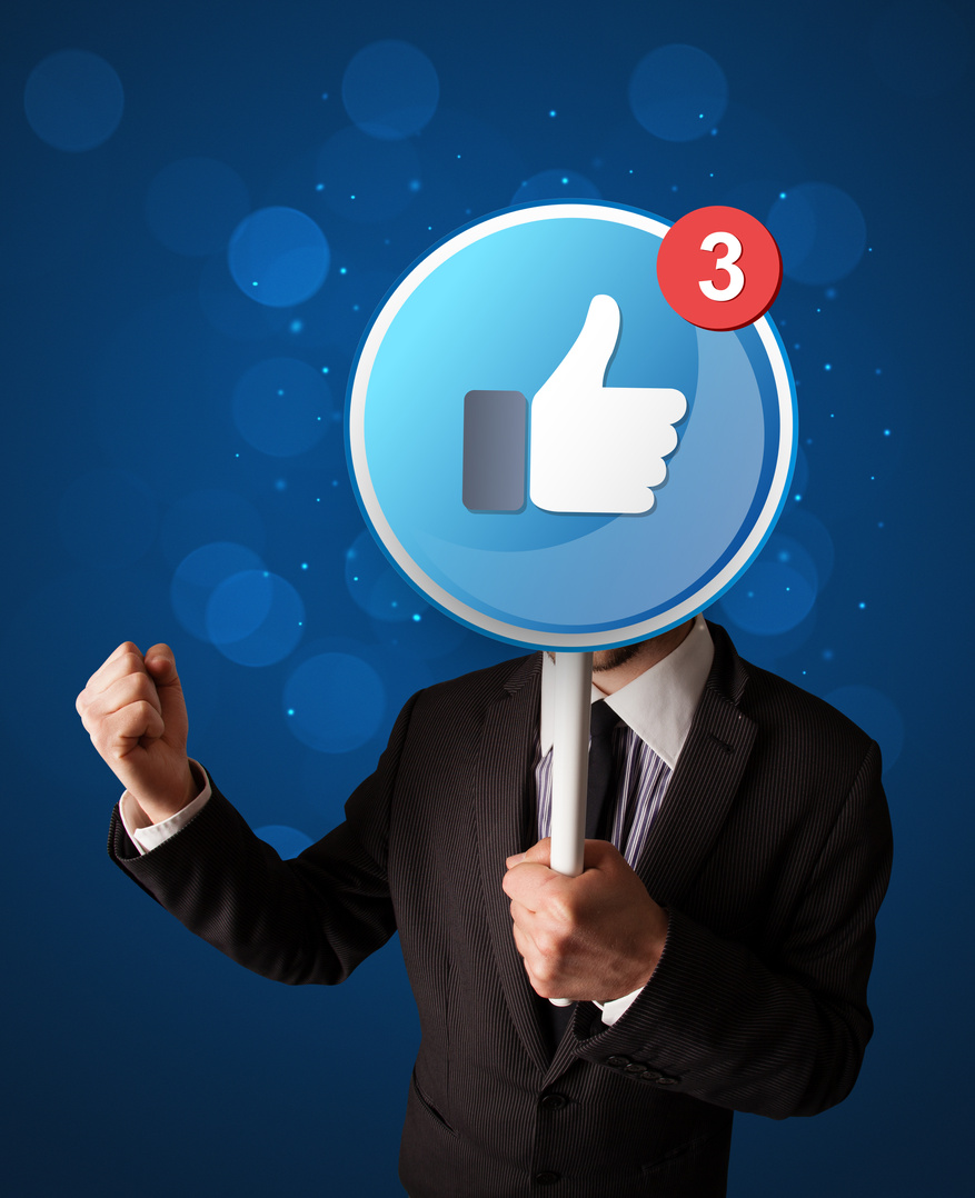 Businessman holding facebook sign